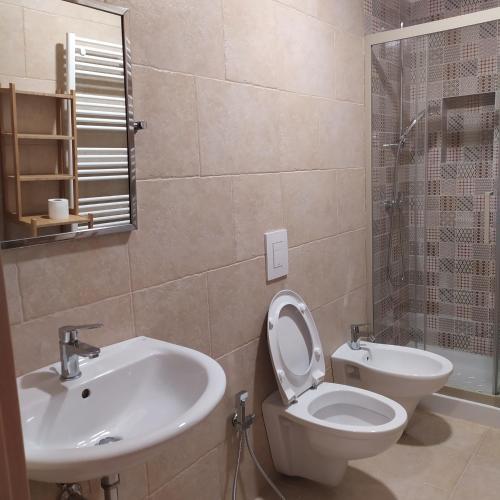 a bathroom with a toilet and a sink at STRADONE 132 in Gravina in Puglia