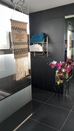 a room with black walls and flowers on a table at Millésime in Perville