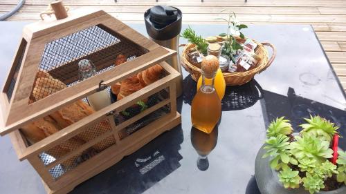 a table with a crate of bread and a basket of plants at Millésime in Perville