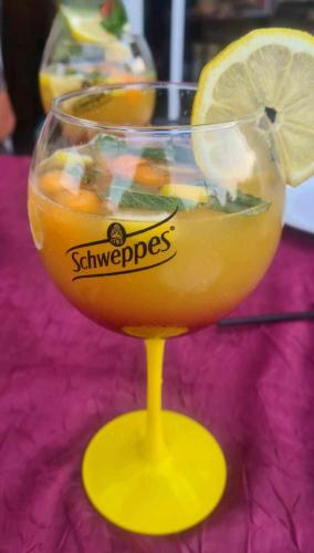 a drink in a glass with a lemon slice in it at Millésime in Perville