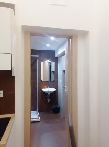 a bathroom with a sink and a mirror at STRADONE 132 in Gravina in Puglia