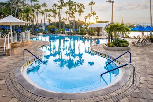 a swimming pool at a resort with palm trees at Marriott's Cypress Harbour Villas in Orlando