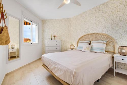 a bedroom with a large white bed and a window at Santa Amalia 39 By IVI Real Estate in Torremolinos