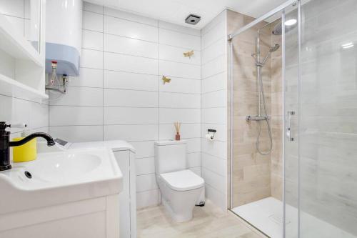 a bathroom with a shower and a toilet and a sink at Santa Amalia 39 By IVI Real Estate in Torremolinos