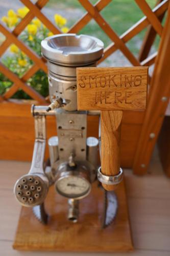 a wooden sign that reads smoking here with a pot and a whisk at House Family Podhum in Dražice