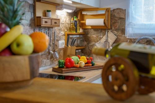 a kitchen with fruits and vegetables on a counter at House Family Podhum in Dražice