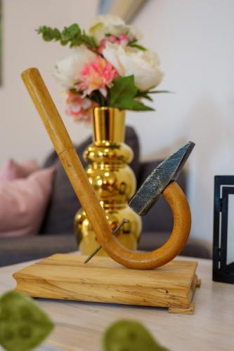 a vase with flowers and a pair of scissors on a table at House Family Podhum in Dražice