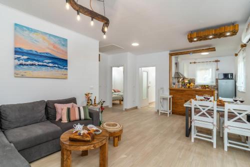 a living room with a couch and a table at House Family Podhum in Dražice