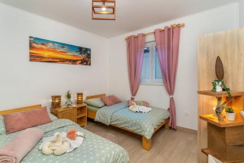 a small bedroom with two beds and a window at House Family Podhum in Dražice