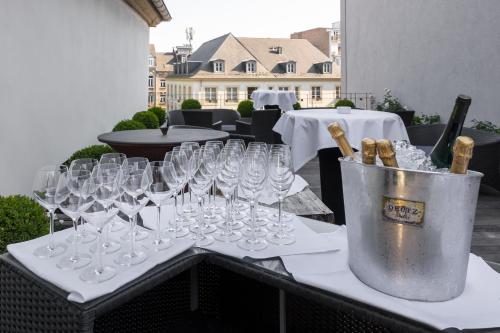 a bunch of wine glasses sitting on a table at Hotel Le Place d'Armes - Relais & Châteaux in Luxembourg