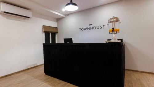 an office with a black counter and a sign on a wall at Super Townhouse RCC Elite in Hyderabad