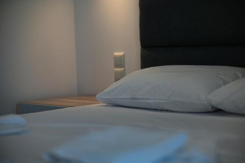 a close up of a bed with a white pillow at Costa Varda Apartments in Mourteri