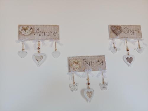 a group of hearts hanging on a wall at CASA NICCA in Oleggio