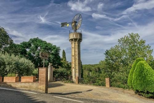 a clock tower with a propeller on top of it at Mas Alba in San Esteban de Guialbes