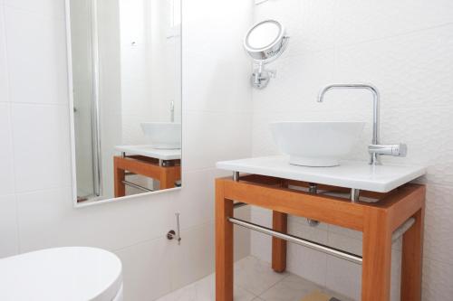 a bathroom with a sink and a mirror at Eva's Urban Apt in Athens 6' to Transit Station in Athens