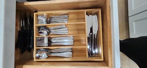 a drawer filled with silver utensils in a kitchen at The Heart Of LA House in Los Angeles