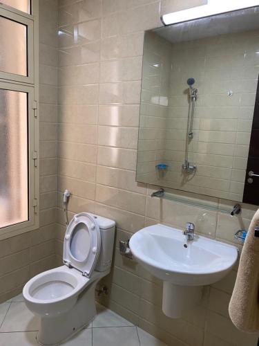 a bathroom with a toilet and a sink at Your Luxury Studio near Airport in Abu Dhabi