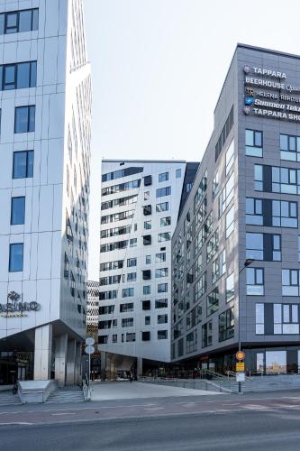 two tall buildings in a city with a street at Stunning Views 11th Floor 2BR Home with Sauna - Hosted by 2ndhomes in Tampere