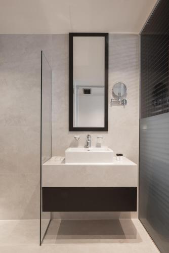 a bathroom with a sink and a mirror at Derand Hotel in Pristina