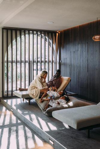 a group of people sitting on beds in a room at POST Family Resort in Unken