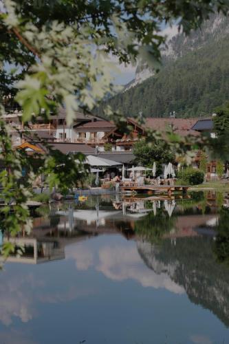 a view of a resort with a reflection in the water at POST Family Resort in Unken