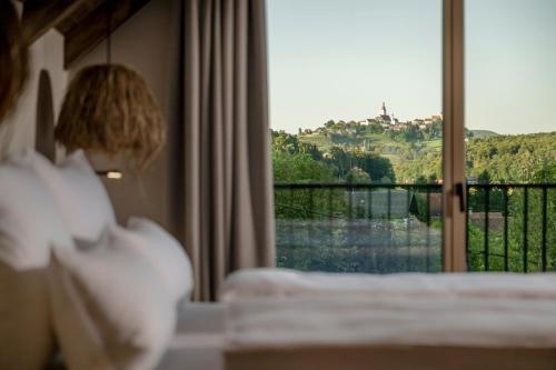 a room with a bed and a window with a view at Julianhof Premium Guesthouse & Spa in Straden