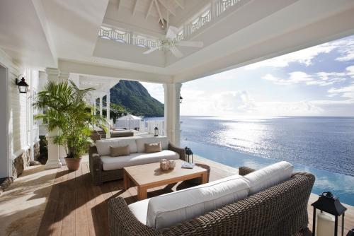 a living room with a view of the ocean at Sugar Beach, A Viceroy Resort in Soufrière