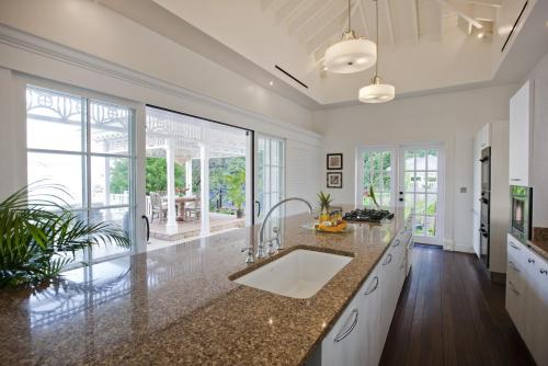 a kitchen with a sink and a large window at Sugar Beach, A Viceroy Resort in Soufrière