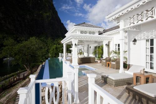 an aerial view of a white house with a swimming pool at Sugar Beach, A Viceroy Resort in Soufrière