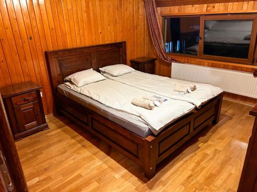 a bedroom with a bed with two stuffed animals on it at Spacious, 3BD home in Radauti in Rădăuţi