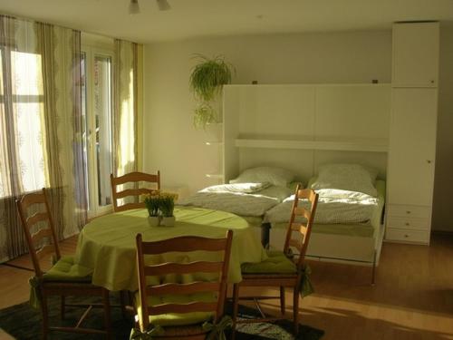 a bedroom with a bed and a table and chairs at Ferienwohnung Andrea Kühlein in Zirndorf