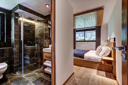 a bathroom with a bed and a shower and a toilet at Black Pearl in Chamonix-Mont-Blanc