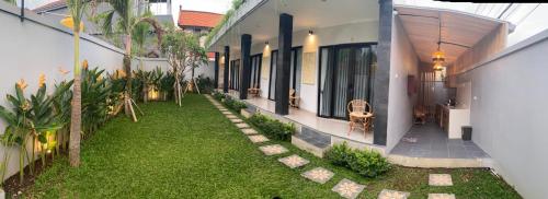 an external view of a house with a yard at Queens Villa in Seminyak