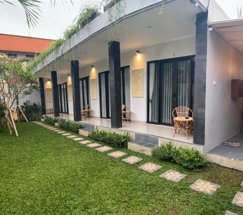 a view of the outside of a house with a green lawn at Queens Villa in Seminyak