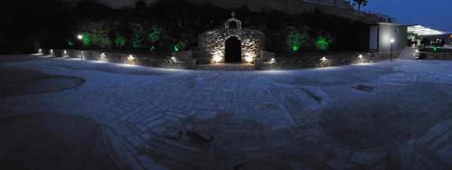 a lit up courtyard at night with a building at Nina Apartment in Chania Town
