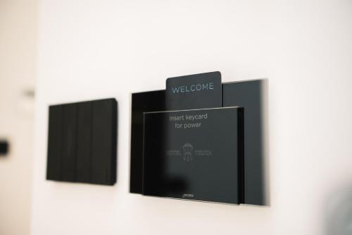 a row of black frames hanging on a wall at Hotel Teuta in Ulcinj