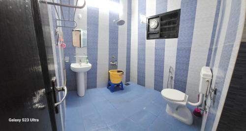 a small bathroom with a toilet and a sink at UDUPI HOMESTAY Garden Villa in Udupi
