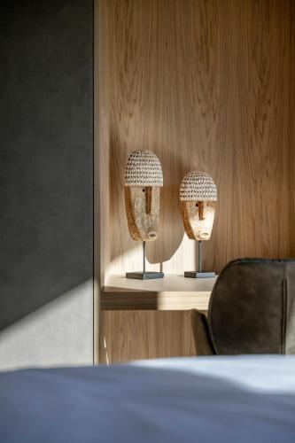 two lights sitting on a shelf with a chair at Julianhof Premium Guesthouse & Spa in Straden