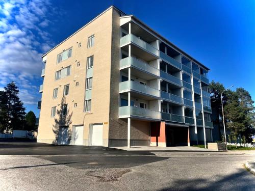 an apartment building with a parking lot in front of it at Cityhome Kaarto in Rovaniemi