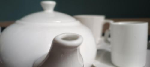 a group of white vases sitting on a table at Logement Chic, résidence azaléa - Alger in Draria