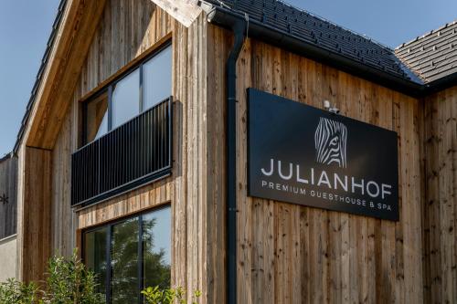 a building with a sign on the side of it at Julianhof Premium Guesthouse & Spa in Straden