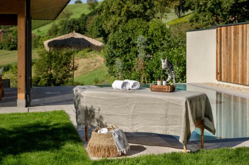 a table with a cat sitting on top of it at Julianhof Premium Guesthouse & Spa in Straden