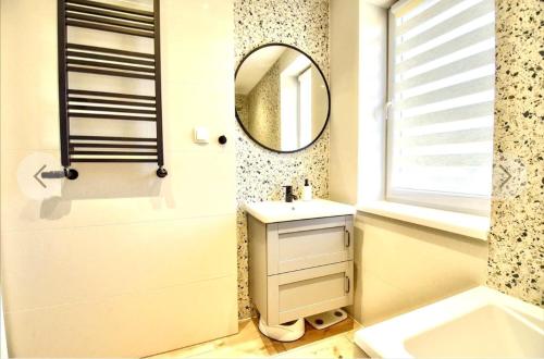 a bathroom with a sink and a mirror at Pokoje goscinne u Brody in Międzybrodzie Żywieckie
