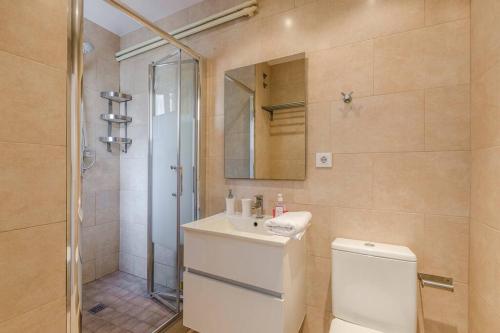 a bathroom with a shower and a toilet and a sink at Canela Homes BARCELONA BALMES in Barcelona