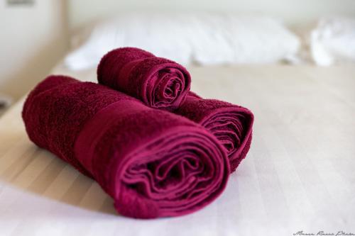 a pair of red towels sitting on a table at Agriturismo Casa del Principe in Torre Bormida