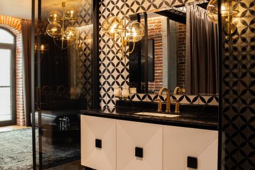 a bathroom with a sink and a mirror at Mandarin Club House in Batumi