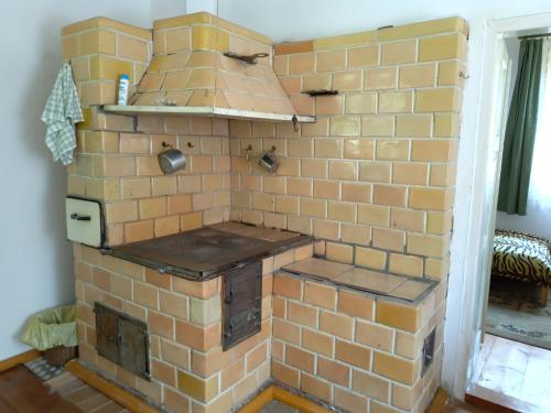 a brick oven in the corner of a room at Leśniczówka Turowo - Podlasie 