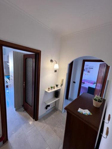 a bathroom with a vanity and a mirror in a room at Casa Elena in Torvaianica