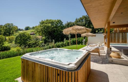 a hot tub in the yard of a house at Julianhof Premium Guesthouse & Spa in Straden