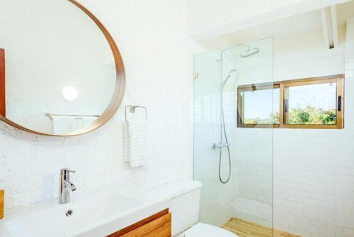 y baño con ducha, lavabo y espejo. en Sunny Vacation Villa No 98, en San Rafael del Yuma